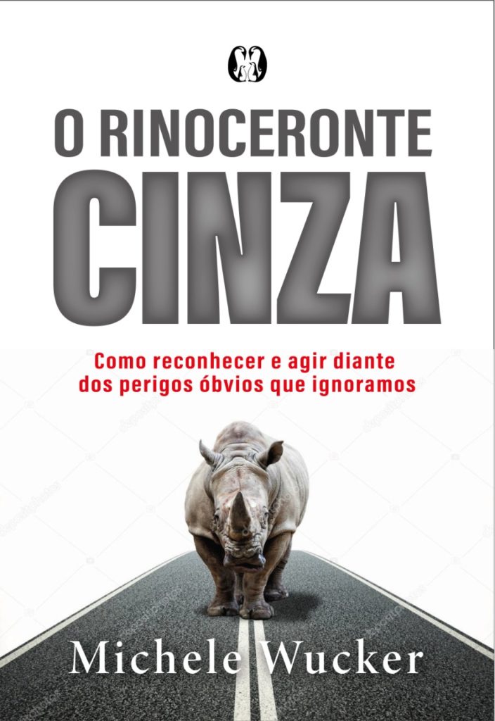 Book cover "O Rinoceronte Cinza" with image of a rhino standing in the media of a paved road staring at the viewer