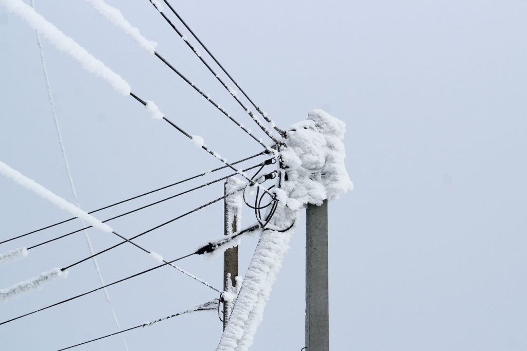 Power lines covered with snow