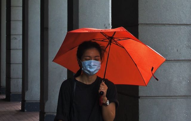 In Celebration of Early Alarms and Prevention Habits Girl with face mask and red umbrella
