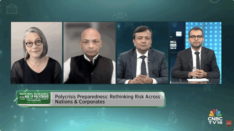 IRM India Affiliate’s What’s the Risk?®️ – National Resilience In The Age of Polycrisis Video feed still of three men and a woman with chyron "Polycrisis Preparedness: Rethinking Risk across Nations and Corporations"