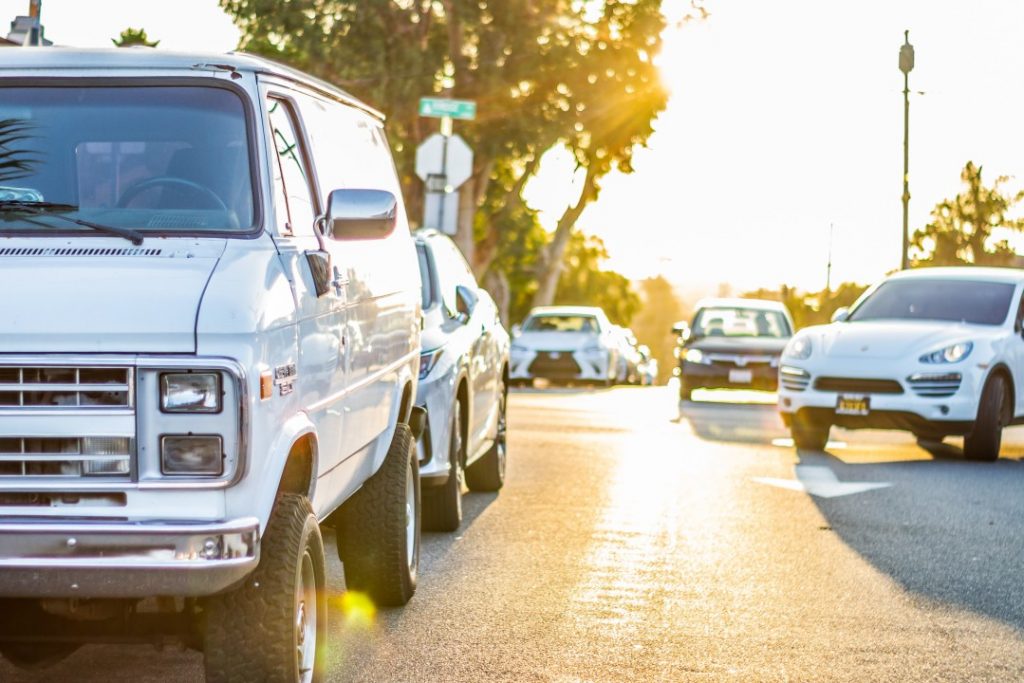 white van and other vehicles along a street