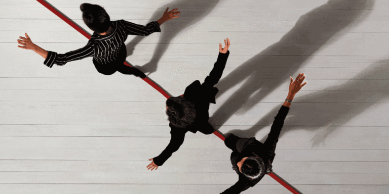 Three people walking on a tightrope