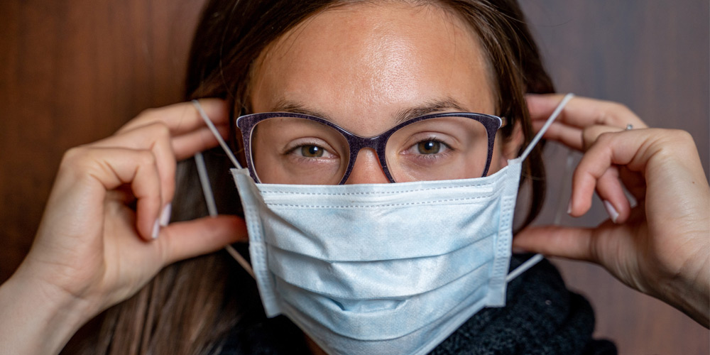strategy+business: Lessons from COVID-19 about communicating risk woman wearing surgical mask